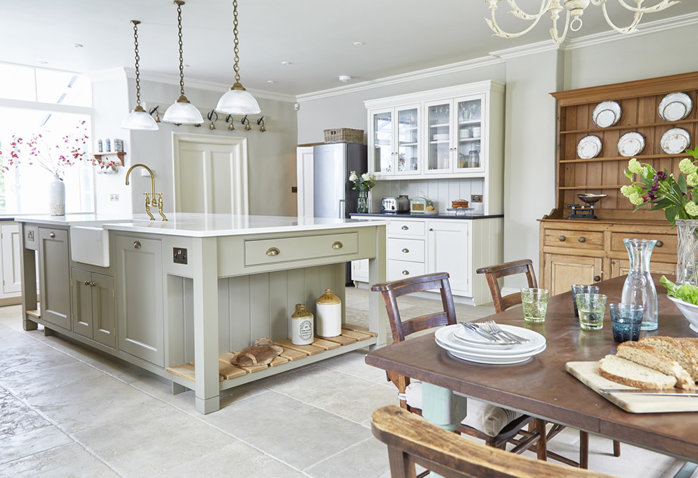 A proper farm house kitchen with stone floors and a huge central kitchen island