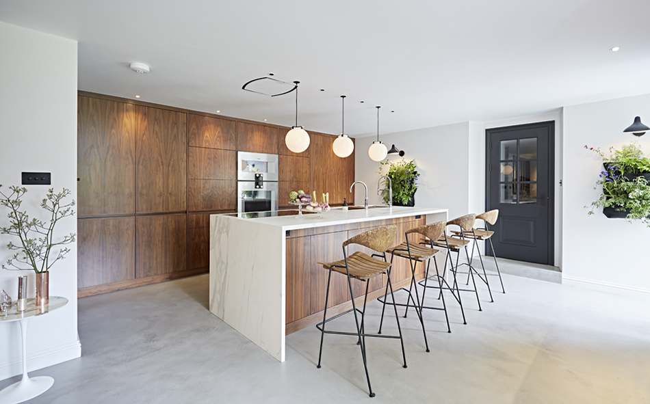 A modern contemporary kitchen with white stone floor and walnut cabinets