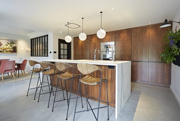 A large well lit contemporay kitchen with dinig table and kitchen island