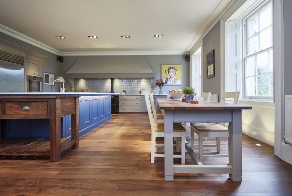 A handmade long wooden table with high back chairs in a Barnes kitchen